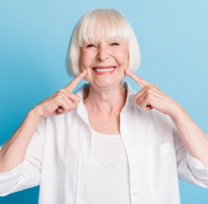 complete Dentures senior woman pointing at Dentures