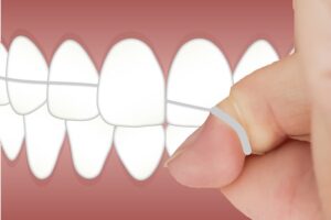 floss wrapped around fingers and teeth